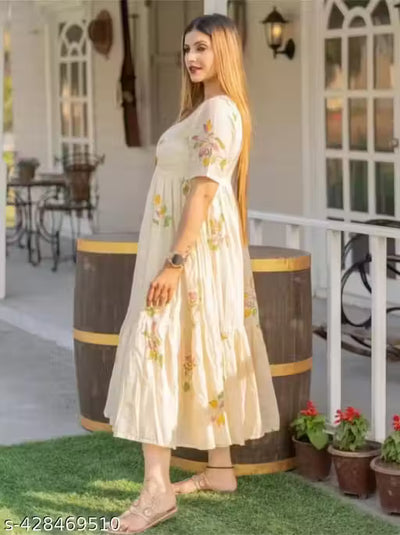 This kurti features a flowing, Anarkali-style design with a cream-colored base and floral hand-painted motifs