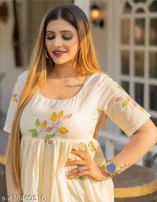 This kurti features a flowing, Anarkali-style design with a cream-colored base and floral hand-painted motifs